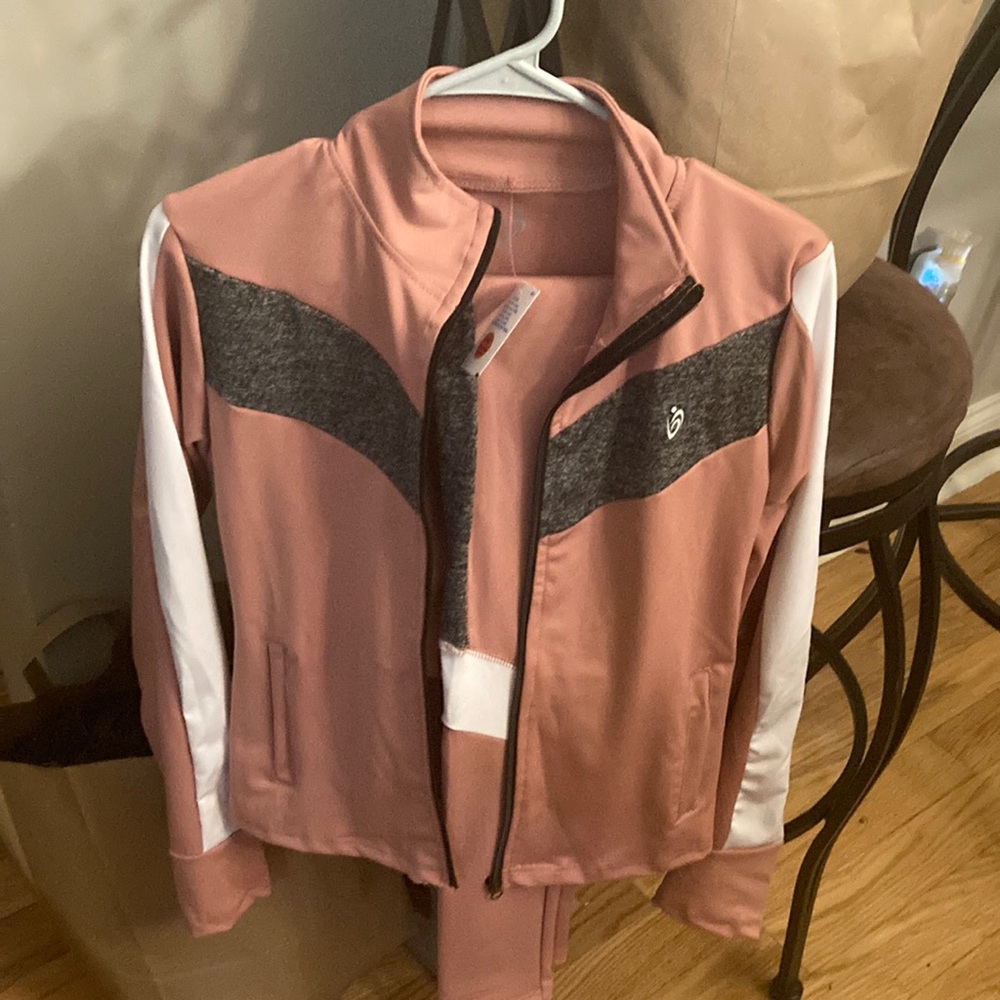 2 piece woman’s jogging suit with tags, brand new never worn pink/ black